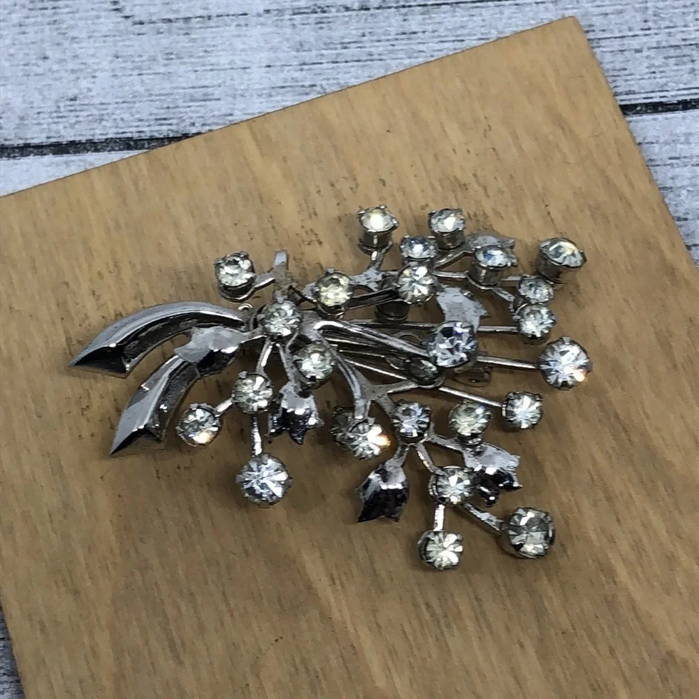 Vintage rhinestone flower branch statement glam brooch.